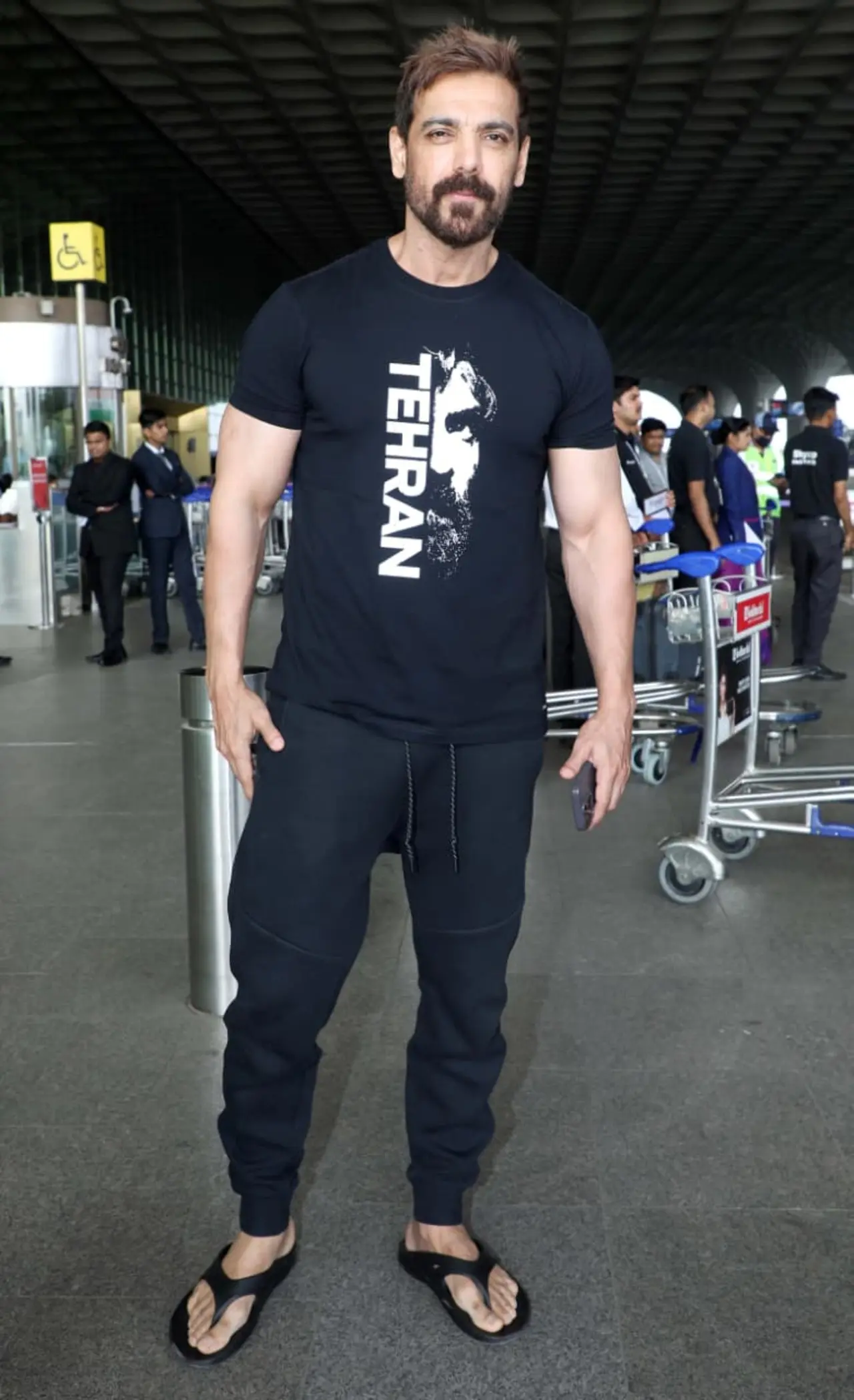 Actor John Abraham was clicked at the Mumbai airport on Tuesday. The actor happily posed for the paparazzi, and also did his signature pose with his thumb up.